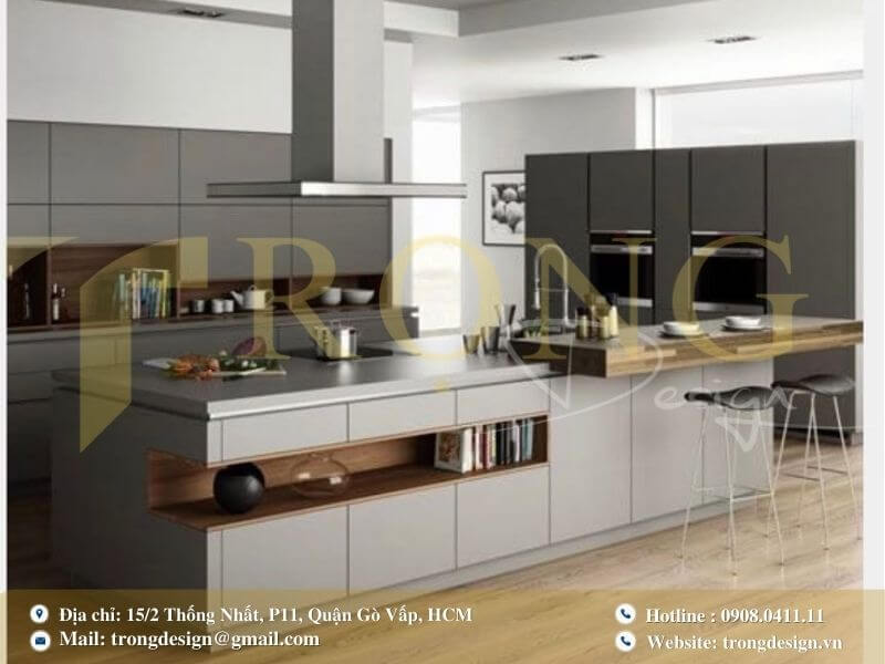 Bếp chữ L với đảo bếp dài tích hợp bàn ăn và sử dụng vật liệu hiện đại.