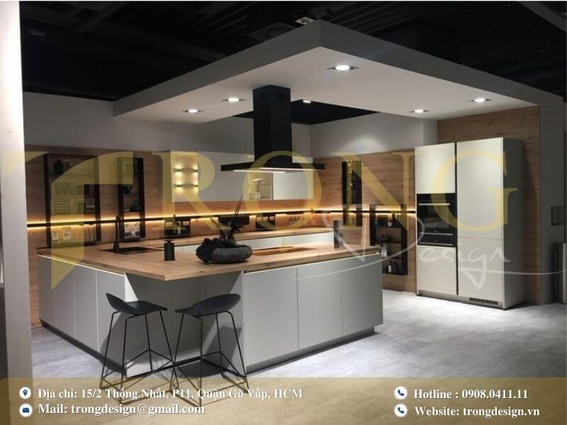 Bếp hiện đại với tủ bếp, đảo bếp tích hợp bồn rửa và khu vực ăn uống nhỏ.