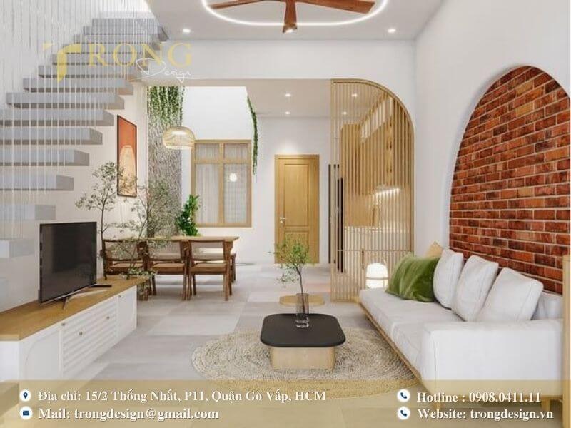 Phòng khách độc đáo với vòm gạch đỏ và cầu thang thiết kế hiện đại, tinh tế.