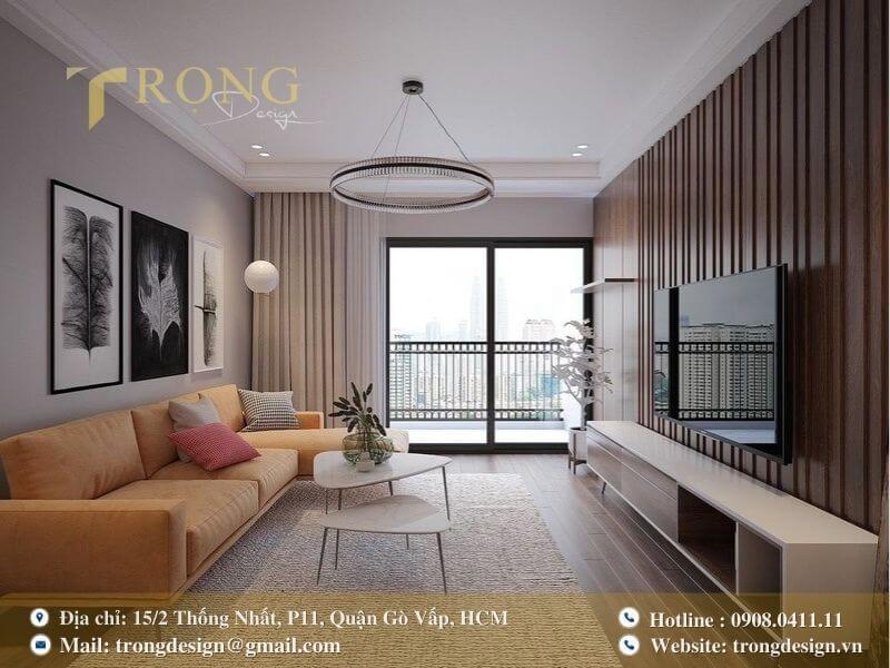 Phòng khách hiện đại, trẻ trung với sofa màu cam đất và tường ốp gỗ sang trọng.